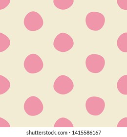 Cute pink dots seamless pattern in pink and light beige. Imperfectly round polka dot all over print design is great for fashion, textiles, wallpaper, gift wrapping paper and home decor items. Vector. 