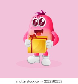 Cute pink monster holding gift box. Perfect for kids, small business or e-Commerce, merchandise and sticker, banner promotion, blog or vlog channel
