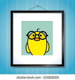 Cute Portrait of Single Yellow Chick wearing Round Spectacles in Picture Frame Hanging on Blue Wallpaper Background