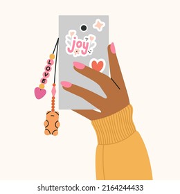 Cute poster with girl's hand holding a phone with a beaded key chain. Beading, handmade, fashion concept. 
Hand drawn vector illustration in trendy colors isolated on beige background.