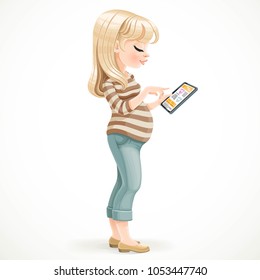 Cute pregnant  blond woman uses an electronic tablet standing in the profile on a white background