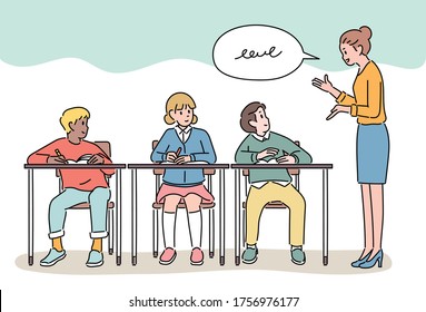 Cute primary school students are sitting at the school desk and taking classes. The teacher is speaking from the side. hand drawn style vector design illustrations. 