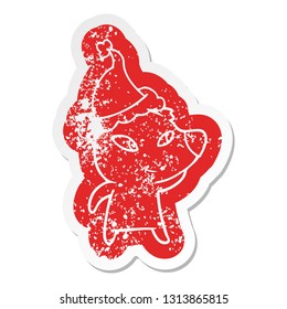 cute quirky cartoon distressed sticker of a bear wearing santa hat