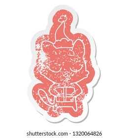 cute quirky cartoon distressed sticker of a cat wearing santa hat