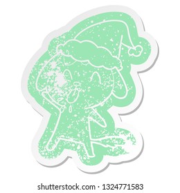 cute quirky cartoon distressed sticker of a dog wearing santa hat