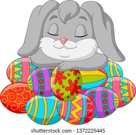 Cute rabbit cartoon sleeping on Easter eggs