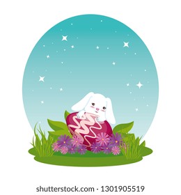 cute rabbit with easter egg painted in the garden