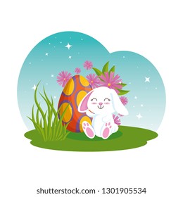 cute rabbit with easter egg painted in the garden