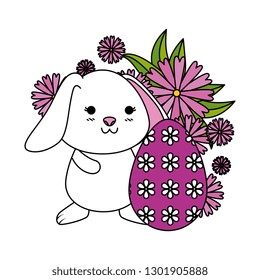 cute rabbit with easter egg painted in the garden