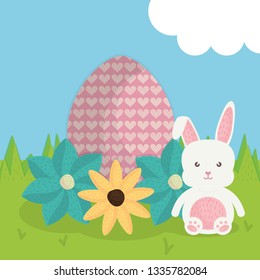 cute rabbit with easter egg painted in the landscape