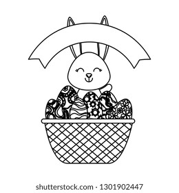 cute rabbit with easter eggs painted in basket
