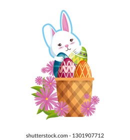 cute rabbit with easter eggs painted in basket