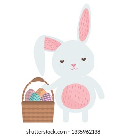 cute rabbit with easter eggs painted in basket