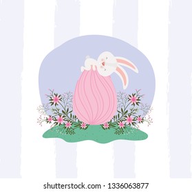 cute rabbit with egg painted and flowers in the garden