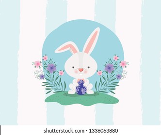 cute rabbit with egg painted and flowers in the garden