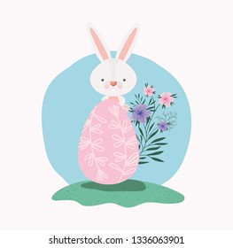 cute rabbit with egg painted and flowers in the garden