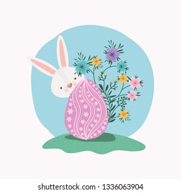 cute rabbit with egg painted and flowers in the garden