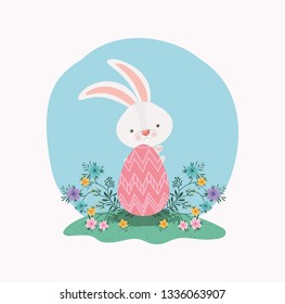 cute rabbit with egg painted and flowers in the garden