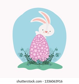 cute rabbit with egg painted and flowers in the garden