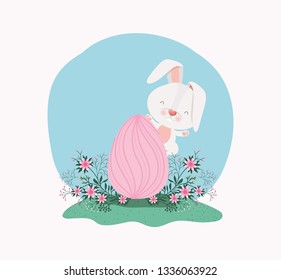 cute rabbit with egg painted and flowers in the garden