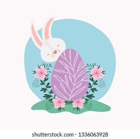cute rabbit with egg painted and flowers in the garden