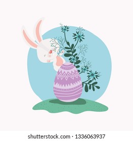 cute rabbit with egg painted and flowers in the garden