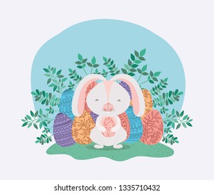 cute rabbit with eggs painted and leafs in the garden