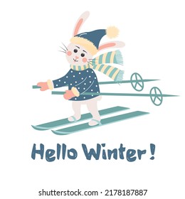 Cute rabbit in hat and scarf is skiing. Hello winter text. New year symbol 2023.