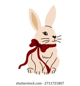 Cute rabbit with a red bow sitting on a white background during the day