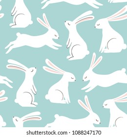 Cute rabbit vector pattern. Hand drawn white bunnies on blue background. Spring easter seamless print.