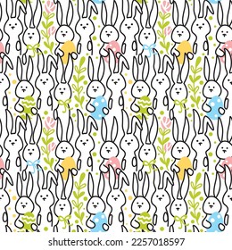 Cute rabbits with colored eggs on the lawn. Easter holiday. Seamless patter. Vector.