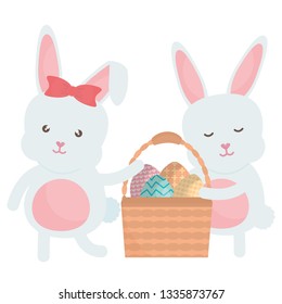 cute rabbits with easter eggs painted in basket