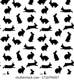 Cute rabbits seamless vector pattern. Many scattered sitting and jumping hares. Isolated. Pink, black, white colors. Symbol of Easter. For printing on fabrics, paper, social media posts, banners.
