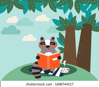 Cute raccoon reads a book under the tree. Funny animal relaxing in park