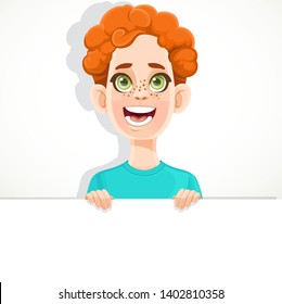 Cute redhaired boy holds large white horizontal banner on a white background