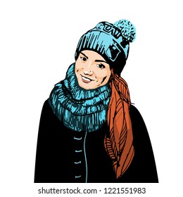 

cute red-haired girl in a hat wrapped in a scarf