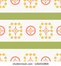 Cute retro seamless pattern in 1970s avocado green, harvest gold and coral. Light background. Mid century vector atomic shapes combined with dots, circles and stripes. Fashion, textiles, home decor.