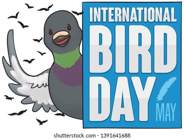Cute rock dove saluting at you behind a blue greeting sign, promoting International Bird Day celebration in May.