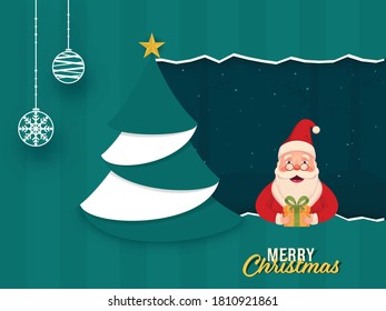 Cute Santa Claus Holding a Gift Box with Paper Xmas Tree and Hanging Baubles on Teal Striped Background for Merry Christmas Celebration.