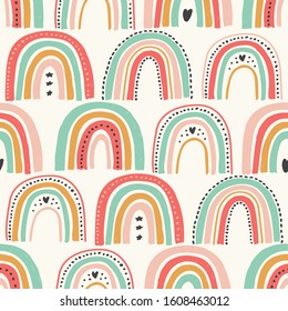 Cute scandinavian childish seamless pattern with trendy hand drawn rainbows in naive art style, can be used as kids texture for fabrics, textile, wallpaper, apparel etc, vector illustration