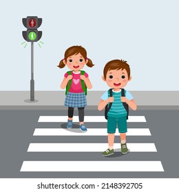 Cute School Kids With Backpack Walking Crossing Road Near Pedestrian Traffic Light On Zebra Cross Way To School