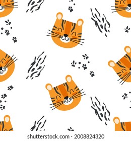 Cute seamless baby pattern with cartoon tiger head and paw prints. Vector background for kids