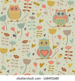 Cute seamless background with flowers and owls in cartoon style.