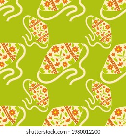 Cute seamless pattern with caps with embroidery and laces. Green background. Flat style illustration.