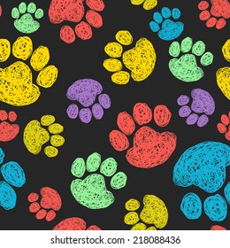 Cute seamless pattern with colorful hand drawn doodle paw prints. Animal tiling background.