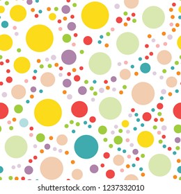 Cute seamless pattern with different size dots in rainbow colors. Vector illustration. Applicable for gift wrapping paper, textile desigtags, birthday greeting cards, sale flyers or party invitations.