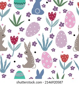 Cute seamless pattern with easter eggs, tulips, rabbits, flowers, grass and dots on a white background.