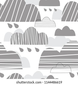 Cute seamless pattern with gray clouds. Gray clouds and raindrops. Rainy sky. Vector illustration of a Scandinavian children's style. Suitable for printing on fabric, bedding, clothing, paper, wallpap