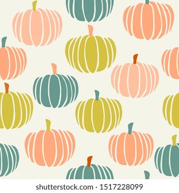 Cute seamless pattern with hand painted pumpkins in green, orange and peach on cream background.