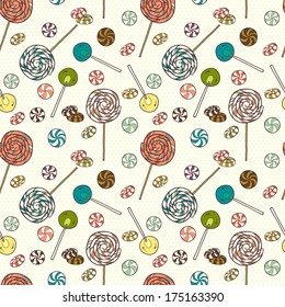 Cute seamless pattern made of hand drawn doodle caramel candies and lollipops on polka dot background. Cartoon sweets background.